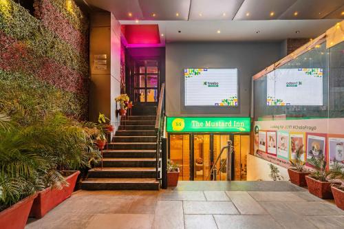 a lobby of a building with stairs and plants at Treebo Premium The Mustard Inn Lawrence Road in Amritsar