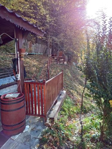 a porch of a house with a barrel in a yard at Casa Ozon in Vulcan