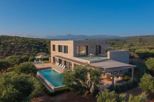 an aerial view of a house with a swimming pool at Messinian Nest in Gialova
