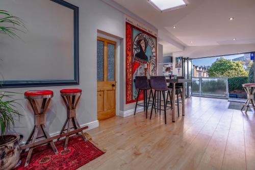 a living room with a table and bar stools at Bright Garden Flat, Private Sauna, Parking in Bristol