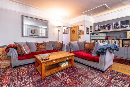 a living room with two couches and a coffee table at Bright Garden Flat, Private Sauna, Parking in Bristol