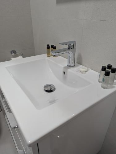 a white bathroom sink with a faucet at St Bridget's Apartments in Galway