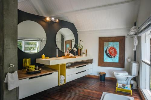 a bathroom with a sink and a toilet and a mirror at The Number 41 in Rivière Noire