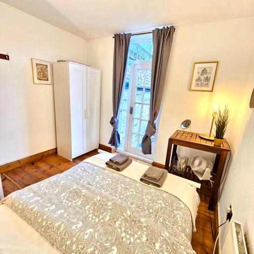 a bedroom with a bed and a large window at Lovely 1 Bed Apartment 2 min to Station in London