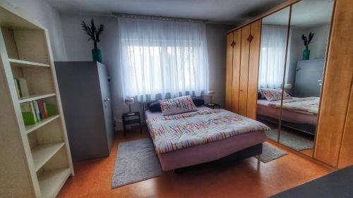 a small bedroom with a bed and a mirror at Ferienwohnung Casa Rossa in Neckarsteinach