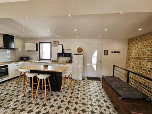 une cuisine avec une table et quelques chaises dans l'établissement L'Etretataise, maison avec parking plein centre, à Étretat