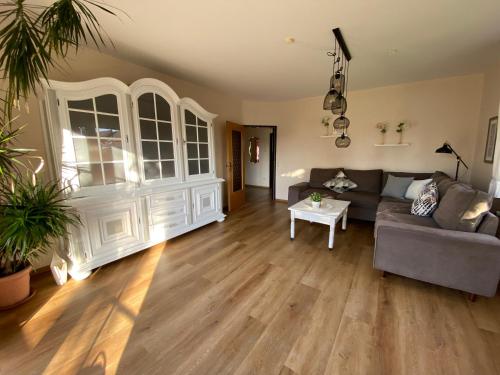 a living room with a couch and a table at Landhaus Muhlenblick, Familie Ehnts in Carolinensiel