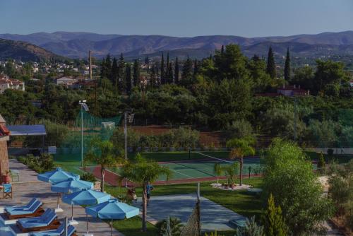 a tennis court with blue lounge chairs and a tennis court at 99 Luxury Exotic Villas in Nafplio