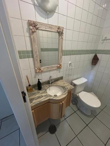 a bathroom with a sink and a toilet at Casa em Juquehy em Condomínio in São Sebastião