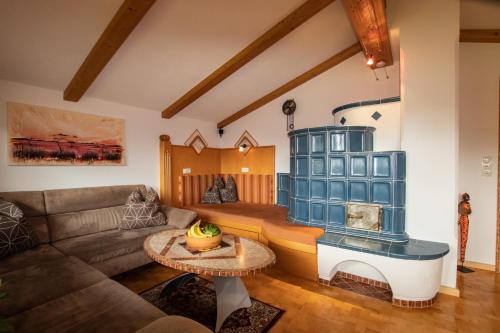 a living room with a couch and a fireplace at Ferienwohnung bis 8 Personen in Panoramalage by FeWo-Plan WILD192 in Thierbach