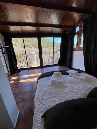 a bedroom with a bed with two towels on it at Casa Rural La Garcia in Puebla de Arenoso