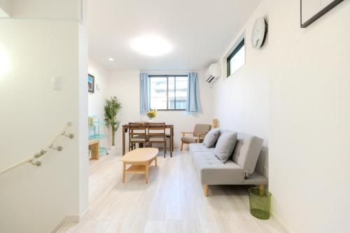 a living room with a couch and a table at Traveler's Home in Tokyo