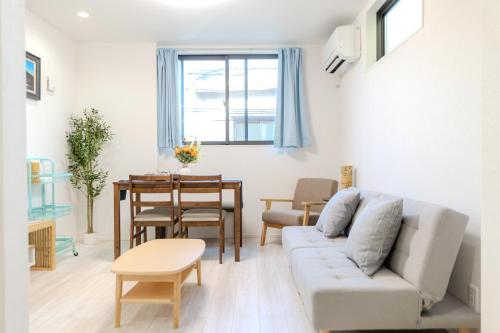 a living room with a couch and a table at Traveler's Home in Tokyo