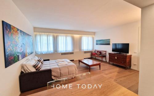 a living room with a bed and a flat screen tv at HT - Residenza Salus con vista su Padova in Padova