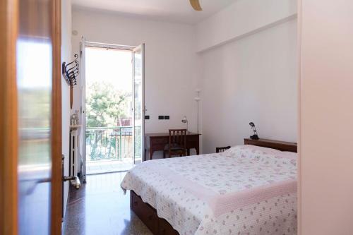 a bedroom with a bed and a large window at Casa Europa - Arenzanohost in Arenzano