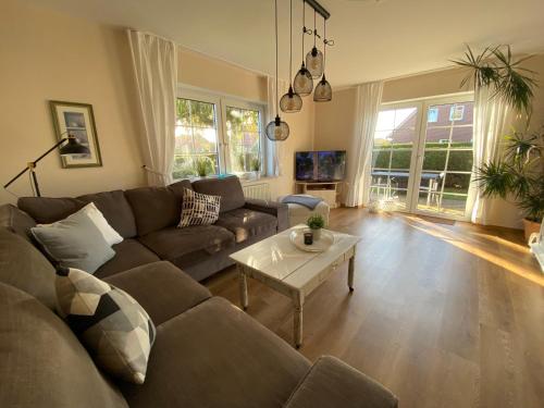 a living room with a couch and a table at Landhaus Muhlenblick, Familie Ehnts in Carolinensiel