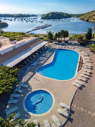an overhead view of a swimming pool with chairs and water at Hotel Calina in Cadaqués