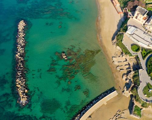 an aerial view of a beach and the ocean at AGATHEA APARTMENT - Central Location, Just 50m from the Sea - Nettuno in Nettuno