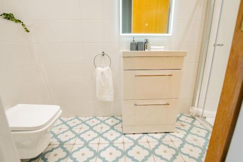a bathroom with a toilet and a sink at Dockside Penthouse - Free Parking in Galway