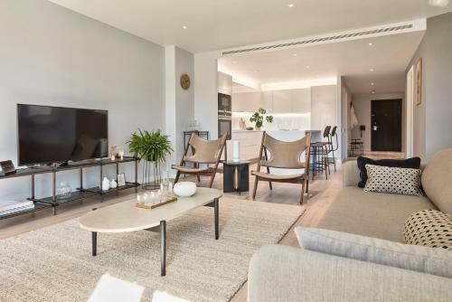 a living room with a couch and a table at Design-led serviced apartments, Camden in London
