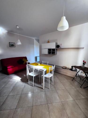 a living room with a table and chairs and a couch at Casa Vacanze Happy Home in Zafferana Etnea