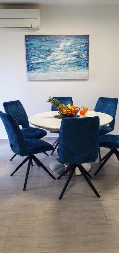 a dining room with a table and four chairs at Apartment JASS next to MALL OF SPLIT in Split