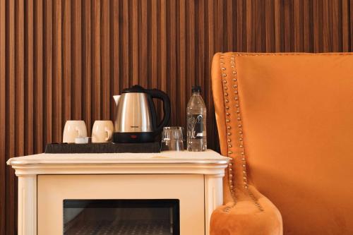 a fireplace with a coffee pot on top of it at Santa Lucia Boutique Hotel in Santa Luċija
