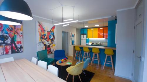 a kitchen with a table and chairs and a bar at Casa Gaea Stay in Braga