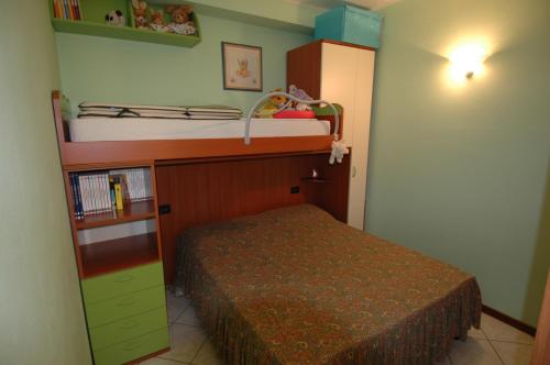 ein kleines Schlafzimmer mit einem Bett und einem Etagenbett in der Unterkunft Appartamento alle Magnolie in Sirmione