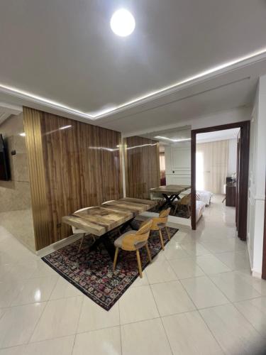 a room with a table and chairs and a bedroom at Appartement Haut Standing 3 chambres proche gare et centre ville in Kenitra