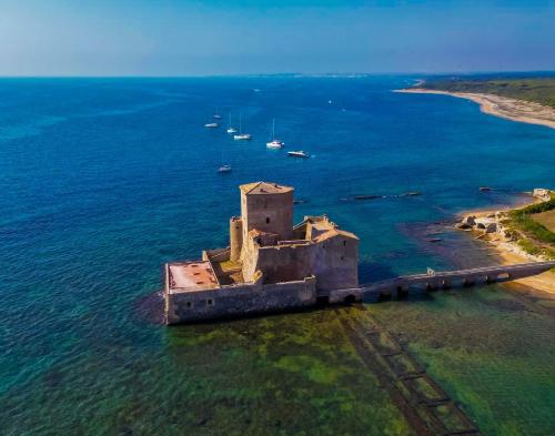 an old building in the middle of the ocean at SANS SOUCIS - Design Apartment - Near Nettuno Center, Beach & Station in Nettuno