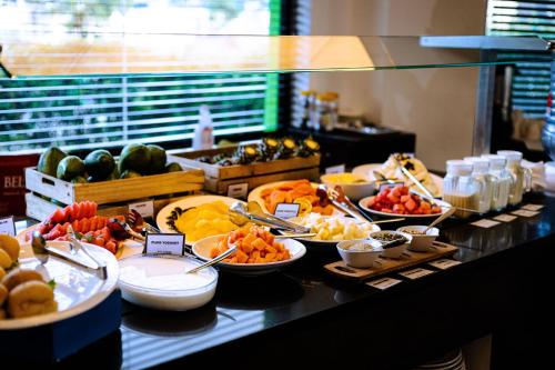 a buffet line with different types of fruits and vegetables at Ibis Styles Accra Airport in Accra