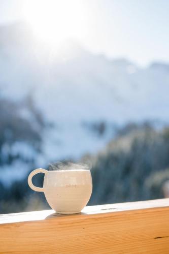 a cup sitting on top of a window sill at Alpennest Arosa in Arosa