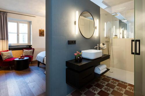 a bathroom with a sink and a mirror at Goldenstern Townhouse in Bolzano
