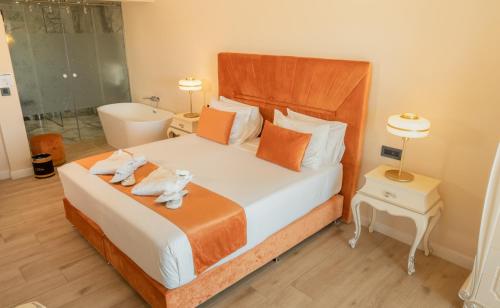 a bedroom with a bed with two towels on it at Santa Lucia Boutique Hotel in Santa Luċija