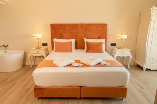 a bedroom with a large bed and a bath tub at Santa Lucia Boutique Hotel in Santa Luċija