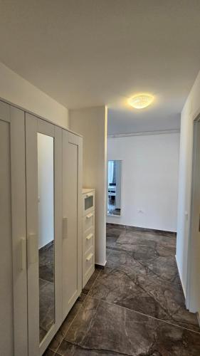 an empty room with a closet and a dresser at Airport Residence in Otopeni