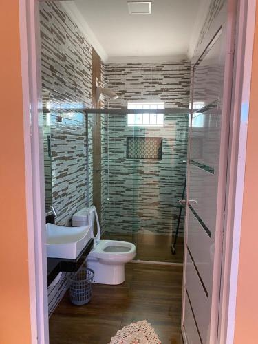 a bathroom with a toilet and a sink at Casa Maria Alice in Manhã