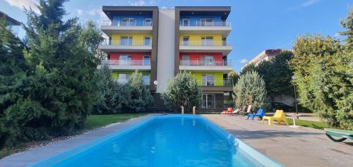 a hotel with a swimming pool in front of a building at Airport Residence in Otopeni