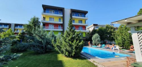 a hotel with a swimming pool in front of a building at Airport Residence in Otopeni