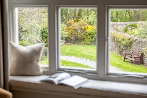 a window with two books on a window sill at Mill End Hotel in Chagford