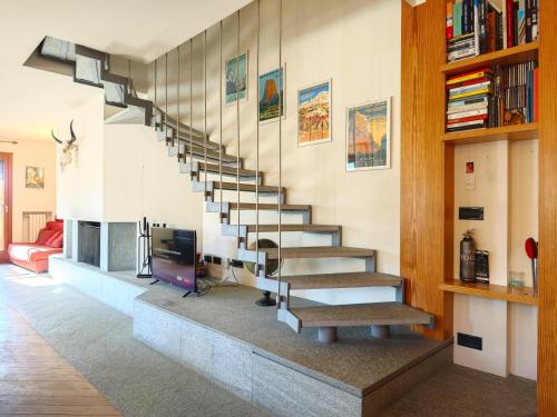 a living room with a spiral staircase in a house at Hostdomus - Urban Villa in Sestriere