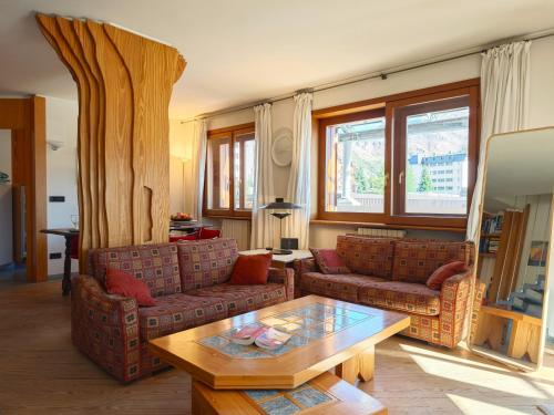 a living room with two couches and a coffee table at Hostdomus - Urban Villa in Sestriere