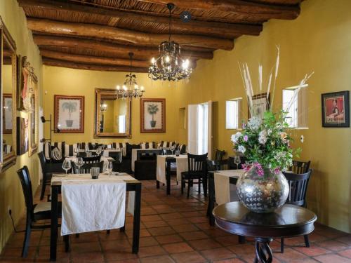 a restaurant with tables and chairs and a vase of flowers at Temenos Retreat in McGregor