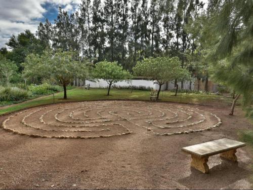 a bench sitting in the middle of a park at Temenos Retreat in McGregor