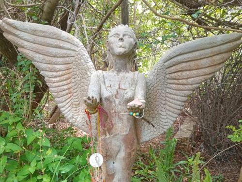 a statue of an angel with spread wings at Temenos Retreat in McGregor