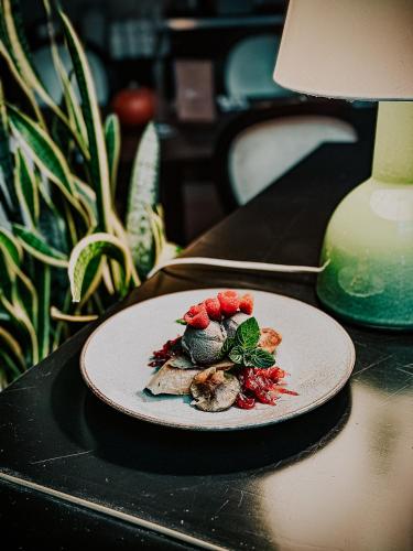 a plate of food sitting on a table at Lawendowe Termy in Uniejow