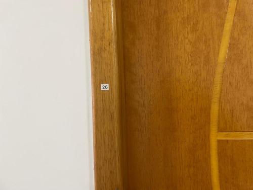 a wooden door with the number next to a room at Condomínio Residencial Vitória 3 in Sao Paulo