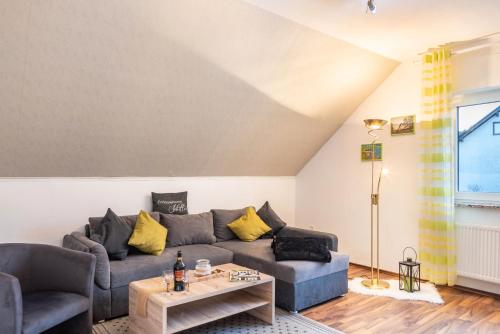 a living room with a couch and a table at Ferienwohnung Schiller in Grebenhain