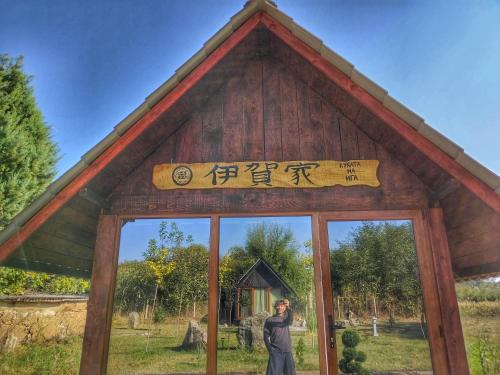 a man taking a picture in front of a building at Japanese Zen Garden and Ninja Village in Macedonia in Kumanovo